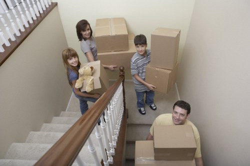Moving crew handling furniture in a Clapham property with stairs